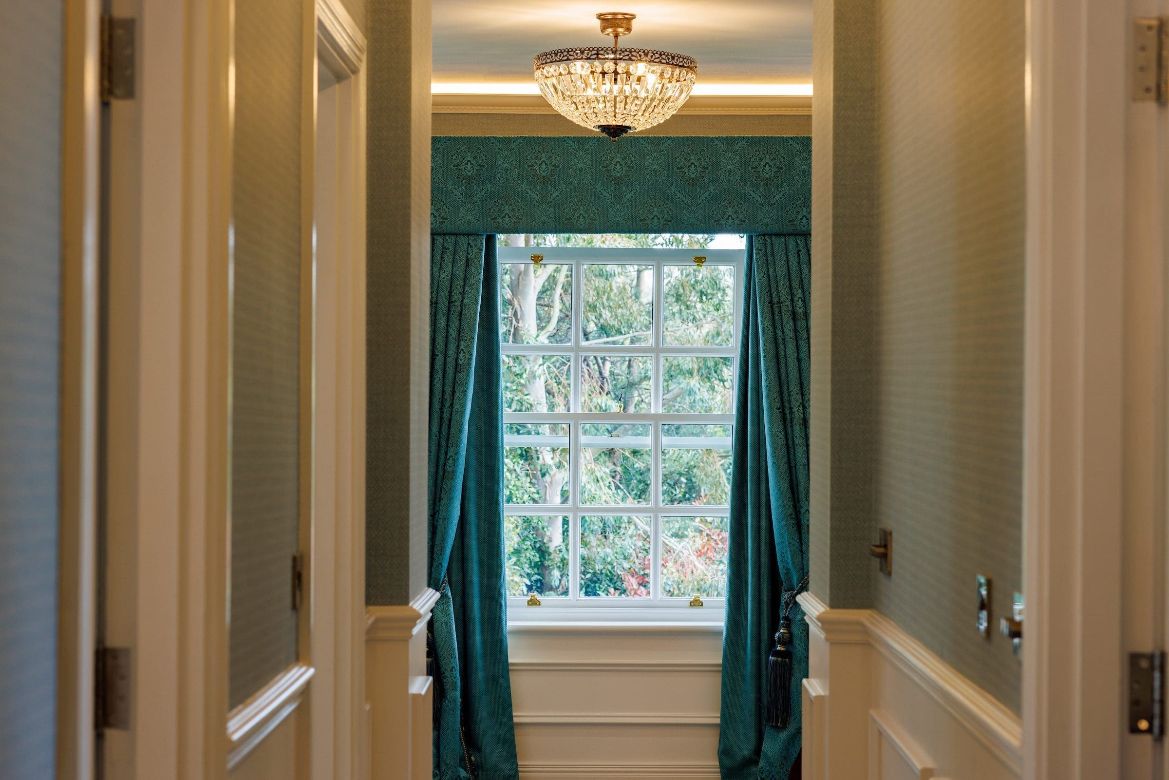 A corridor with window curtains in Rochtaine Mansion.