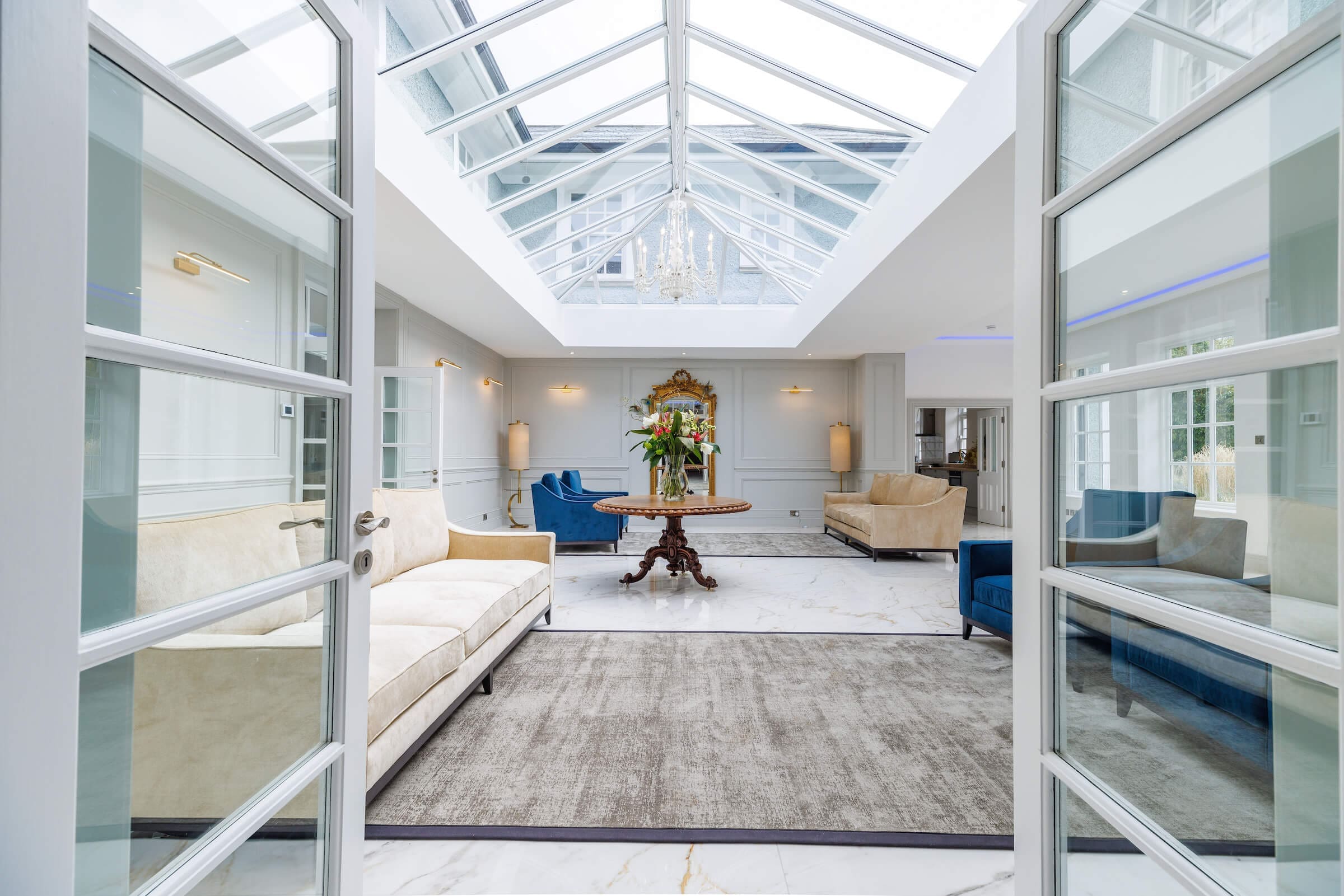 view_through_glass_doors_gallery_seating_area_marble_floor_atrium_rochtaine_mansion_mount_juliet_kilkenny
