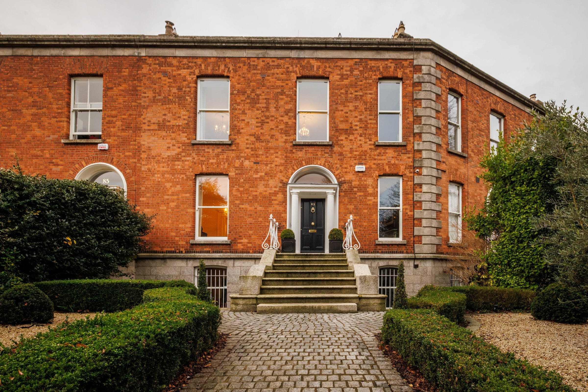 Front view of Rochtaine Ballsbridge, displaying the house's classic architecture and well-kept garden.